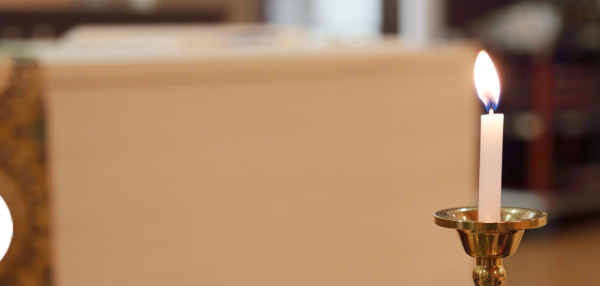 Candle with blurred background of funeral home