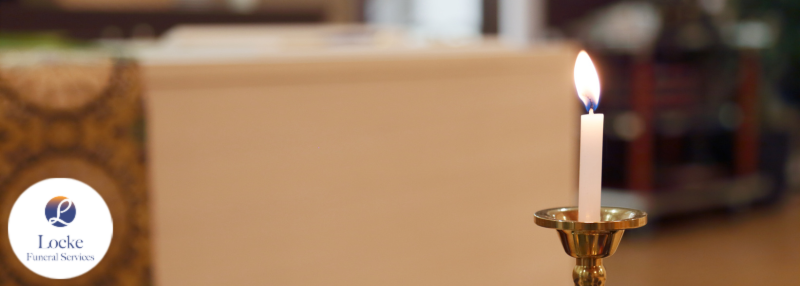Candle with blurred background of funeral home