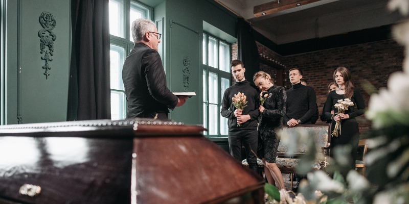 People gathered around to listen to funeral conductor